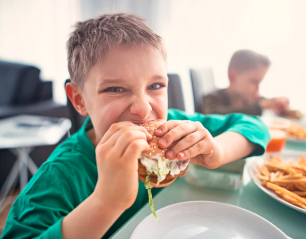 Happy child trying new food after picky eating therapy